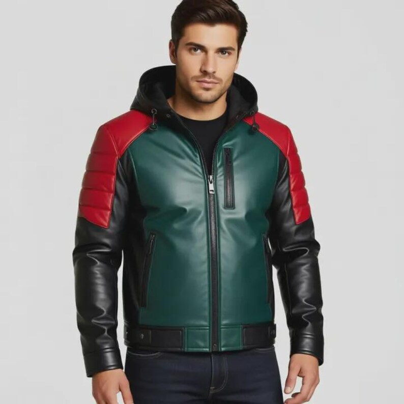 May include: A colour-block leather jacket with a hood. The jacket has red padded shoulders, a green central panel, and black sleeves. It features a front zip and a black hood.