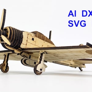 May include: A laser-cut wooden model of a propeller airplane with a matching standing pilot figure. The model features detailed panel lines and a three-blade propeller. The text AI DXF NC SVG LBRN is printed in blue in the upper right corner.