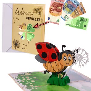 May include: A pop-up card with a ladybug holding a dandelion. The card is open and the ladybug is popping out. The card has a green grass background and the words "Wunsch Erf&uuml;ller" on the front.