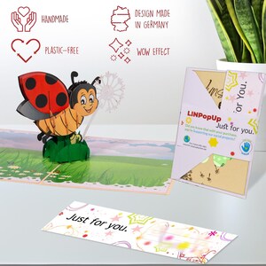 May include: A 3D pop-up card featuring a ladybug with a dandelion. The card is made of paper and has a colorful design. The card is handmade and plastic-free. The card is designed in Germany and has a wow effect. The card says "Just for you." on the front and inside.