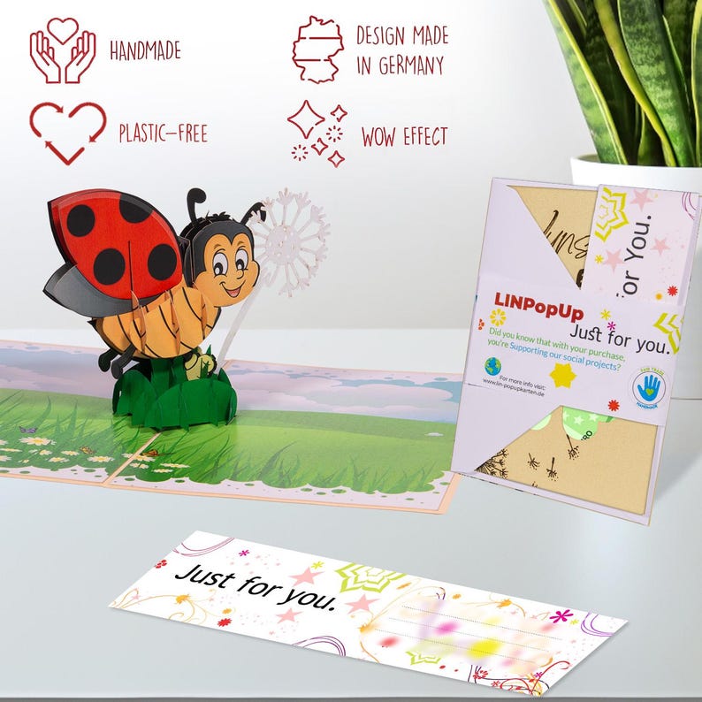 May include: A 3D pop-up card featuring a ladybug with a dandelion. The card is made of paper and has a colorful design. The card is handmade and plastic-free. The card is designed in Germany and has a wow effect. The card says "Just for you." on the front and inside.