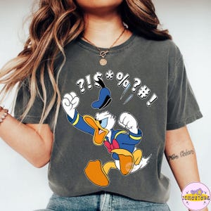 May include: A set of three ceramic mugs with a speckled, matte finish. The mugs are in shades of cream, light gray, and dark gray. Each mug has a simple, minimalist design and a rounded handle.