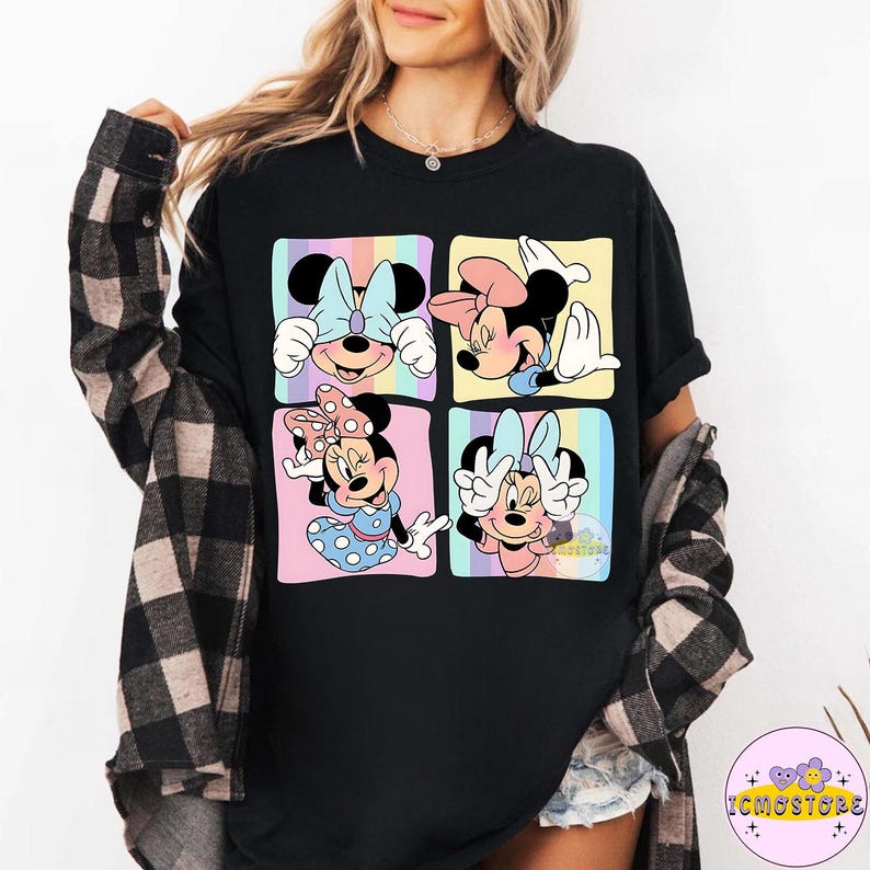 May include: Black t-shirt featuring a colorful graphic of Minnie Mouse in four different poses. Each pose is set within a pastel-colored square. The shirt has a crew neck and short sleeves. The text "ICMOSTORE" is visible on the bottom right.
