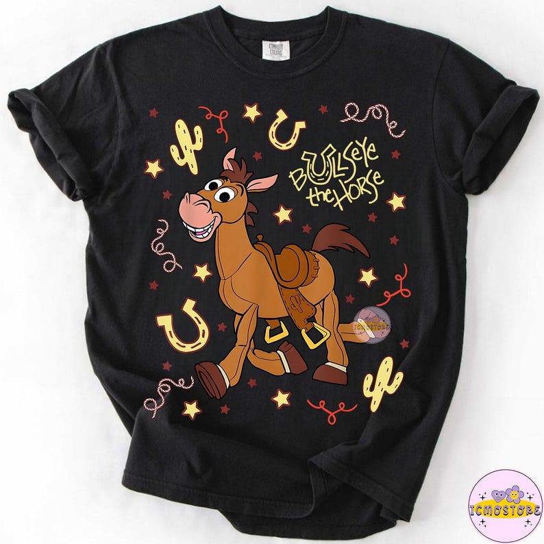 May include: Black t-shirt featuring a cartoon image of Bullseye the horse from Toy Story. The design includes stars, horseshoes, and cacti. The text "Bullseye the Horse" is also printed on the shirt.