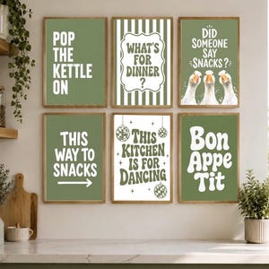May include: A set of six rectangular wall art prints with a sage green and white colour scheme. The prints feature various kitchen-themed phrases including Pop The Kettle On, What's For Dinner, Did Someone Say Snacks, This Way To Snacks, This Kitchen Is For Dancing, and Bon Appetit, along with illustrations of three geese and disco balls.