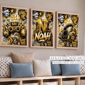May include: Three framed art prints with a gaming theme. The prints feature a gold and black colour scheme with a controller, the name "Noah", and headphones. The text "Game On", "Level Up", and "Beast Mode" are also visible.
