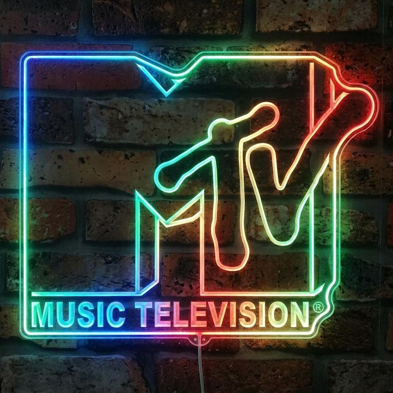 May include: A rectangular neon sign featuring the MTV logo with the text MUSIC TELEVISION in a gradient of blue, green, yellow, and red light. The sign is outlined in a glowing neon tube, creating a vibrant display of the iconic music brand logo.