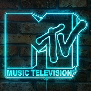 May include: A bright cyan neon sign displaying the MTV logo with the text MUSIC TELEVISION and a registered trademark symbol. The sign features a bold, stylised M and TV lettering outlined in glowing light, creating a vibrant visual effect.