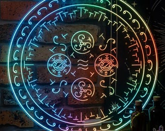 May include: A glowing, circular, multi-colored LED light with intricate symbols and patterns. The light is set against a brick wall and a dark background. An open book with handwritten text and bottles are in the foreground.