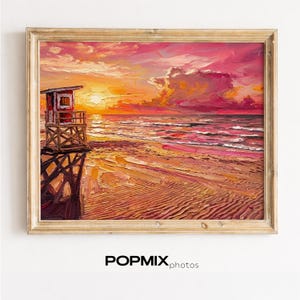 May include: Oil painting of a beach scene at sunset. The artwork features a lifeguard stand on the left, with the sun setting over the ocean. The sky is filled with shades of pink, orange, and yellow. The painting is in a wooden frame.