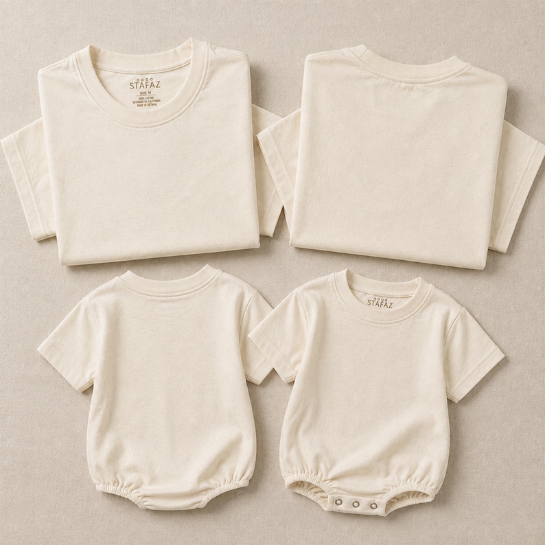 May include: Two cream-colored short-sleeve t-shirts and two cream-colored short-sleeve baby rompers. The t-shirts feature a printed label inside the neck reading STAFAZ, size M, 100% cotton, made in Vietnam. The rompers have a snap-button closure.