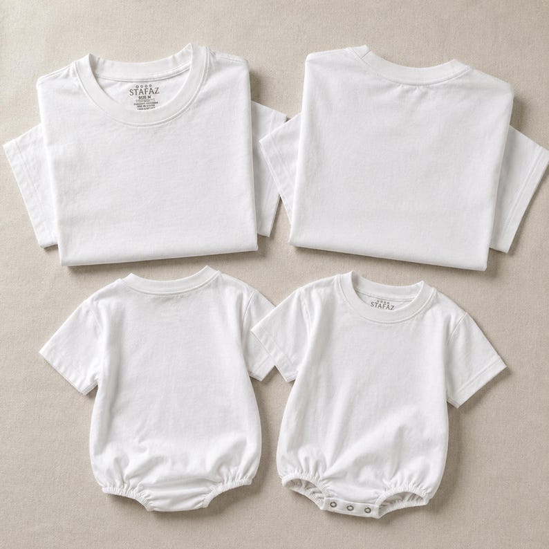 May include: Two plain white short-sleeved t-shirts and two plain white short-sleeved baby bodysuits with snap closures at the bottom. Each garment features a round neckline and the Stafaz brand label printed on the inside of the collar area.