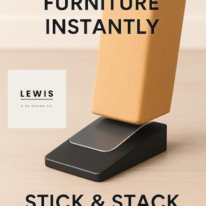 May include: A black and clear furniture wedge is shown supporting a wooden table leg. The text "FIX WOBBLY FURNITURE INSTANTLY" and "STICK & STACK WEDGE" are displayed. The product is from LEWIS A 3D DESIGN CO.