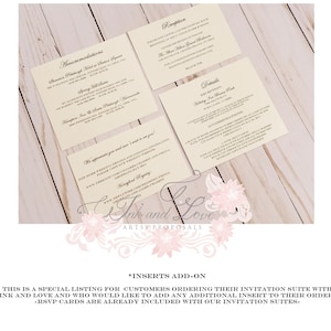 May include: Cream-colored wedding invitation inserts with black text, including details for accommodations and reception. The inserts are arranged on a light wooden surface, with floral accents and the text "Ink and Love Artsy Proposals."