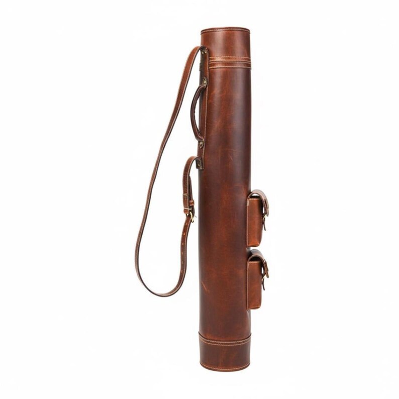 May include: A brown leather quiver with a shoulder strap and two small pouches. The cylindrical quiver has a handle and is stitched with light-colored thread. The leather has a slightly distressed appearance.