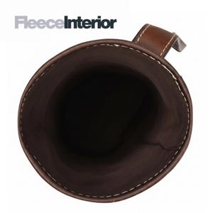 May include: A brown leather cup or holder with a handle, featuring white stitching along the rim. The interior is dark brown. The text "FleeceInterior" is in the upper left corner.