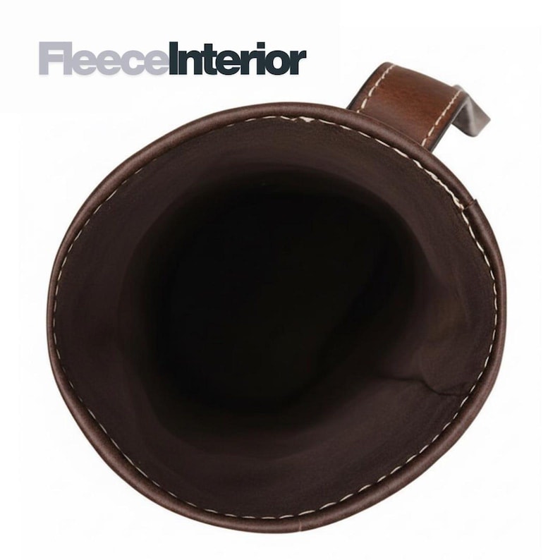 May include: A brown leather cup or holder with a handle, featuring white stitching along the rim. The interior is dark brown. The text "FleeceInterior" is in the upper left corner.