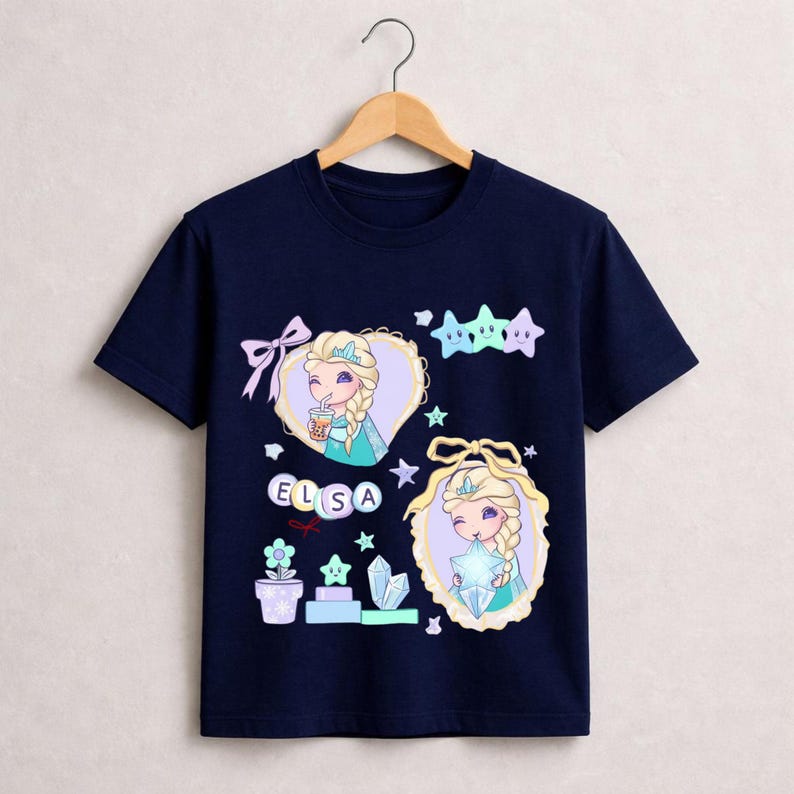 May include: A navy blue t-shirt with a cartoon illustration of Elsa from Frozen. The design includes Elsa's name, stars, and other decorative elements. The shirt is made of a soft, comfortable material.