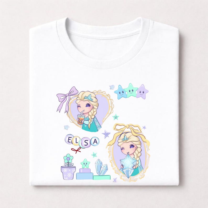 May include: White t-shirt with a cartoon illustration of a princess with blonde braids, wearing a crown and a teal dress. The design includes stars, a bow, and the name "ELSA". The princess is holding a star and a drink.