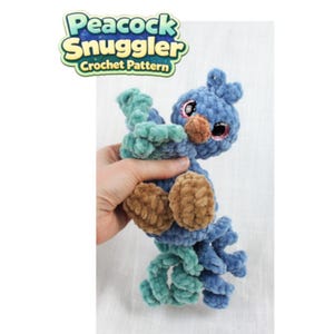 May include: A handmade, blue and teal crochet peacock toy with brown accents. The plush peacock has a round body, a small head, and a long tail. The text "Peacock Snuggler Crochet Pattern" is in the upper left corner.