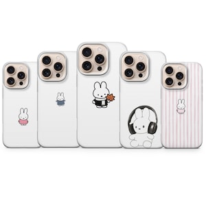 May include: A collection of white phone cases featuring cartoon bunny designs. The cases display different bunny illustrations, including one with headphones, one with a leaf, and others in various outfits. Some cases have pink stripes.