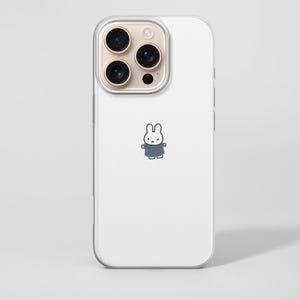 May include: A white phone case with a clear border. The case features a small cartoon bunny wearing a blue outfit. The phone's camera lenses are visible at the top. The background is a solid white.