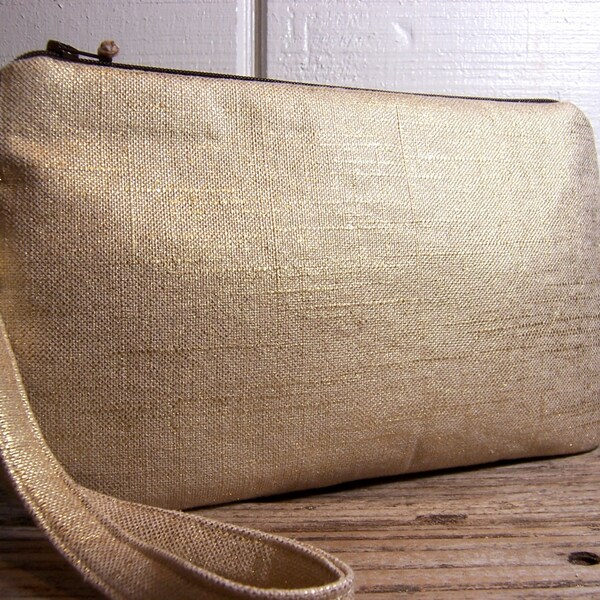 Large wristlet made of a pretty linen and gold fabric . Perfect for parties very festive  large key fob strap.