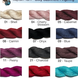 May include: A range of Silky Cashmere Fingering yarn in colours such as Shell, Cherry Blossom, Cabernet, Carmin, Onyx, Blue, Peony, Charcoal, Taupe, Cold Pink, Bright Red, Turquoise, Cornflower, and Night Blue. The image includes the text "Captain Yarn - Silky Cashmere Fingering".
