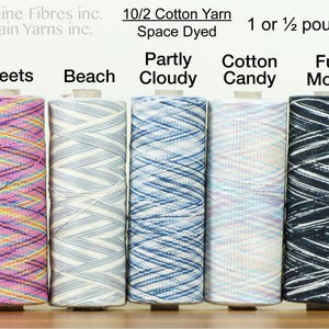 May include: Five spools of 10/2 cotton yarn in different space dyed colors. The colors are Sweets, Beach, Partly Cloudy, Cotton Candy, and Full Moon. Each spool is 1 or 1 1/2 pounds.