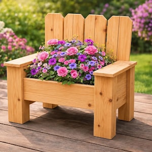 May include: A light brown wooden planter shaped like a chair with a slatted backrest and flat armrests. The seat area is filled with a vibrant arrangement of pink, purple, and blue flowers with green foliage, creating a decorative garden display.