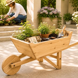 May include: A light-colored wooden wheelbarrow filled with various potted green plants, small seed starter trays, paper seed packets, a metal hand trowel, and gardening gloves, featuring a single front wheel and sturdy wooden support legs.