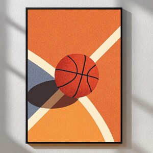 May include: Framed print of a basketball on a court. The orange basketball with black lines sits on an orange background with white and blue court lines. The artwork has a textured, dotted appearance, with a black frame.