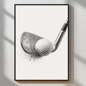 May include: Monochrome print of a golf club striking a golf ball. The club is positioned at an angle, with the ball making contact and producing a spray effect. The image is framed within a black border.