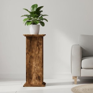 May include: A wooden plant stand with a square top and base, holding a potted green plant. The stand is made of dark, weathered wood. The plant stand is in a bright, minimalist room. The stand is approximately 100 cm tall.