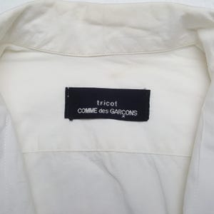 May include: A set of three ceramic mugs with a speckled, matte finish. The mugs are in shades of cream, light gray, and dark gray. Each mug has a simple, minimalist design, perfect for coffee or tea.