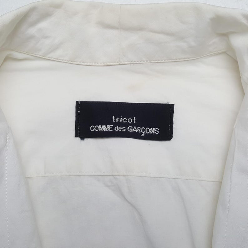 May include: A set of three ceramic mugs with a speckled, matte finish. The mugs are in shades of cream, light gray, and dark gray. Each mug has a simple, minimalist design, perfect for coffee or tea.