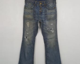 Jeans de mezclilla True Religion USA vintage, desgastados y de corte bota.