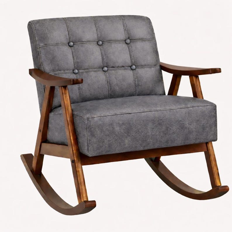 May include: A gray upholstered rocking chair with a tufted back and seat. The chair has a wooden frame and armrests. The rocking chair is designed for comfort and relaxation. The chair's dimensions are not visible in the image.