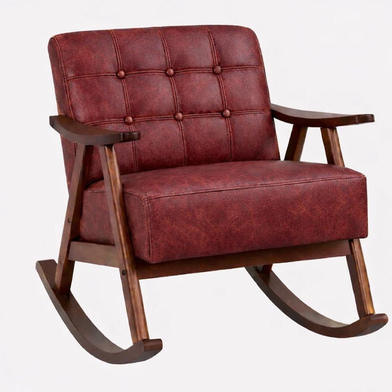 May include: A red leather rocking chair with a button-tufted back and seat. The chair has dark wooden armrests and a wooden frame. The rocking chair is designed for comfort and relaxation.