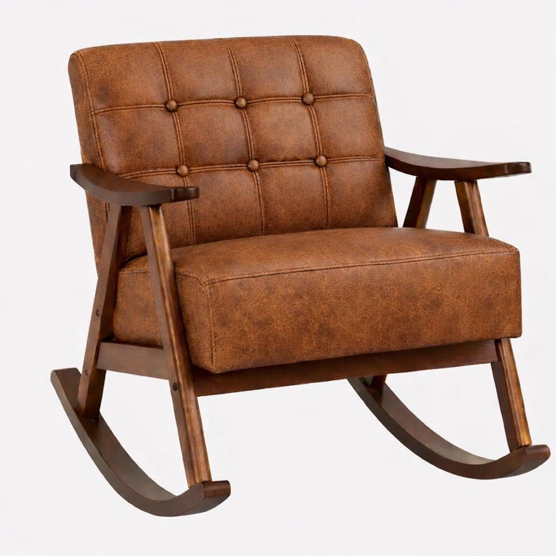 May include: A brown leather rocking chair with a tufted back and seat. The chair has wooden armrests and a wooden frame. The rocking chair is designed for comfort and relaxation. The chair's dimensions are approximately 35 inches wide, 38 inches deep, and 36 inches high.