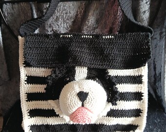black and white shoulder bag with a cute embossed dog head.