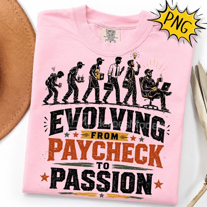 May include: A light pink t-shirt featuring a graphic illustration of a person evolving through various stages of work, from carrying items to sitting at a desk. The text reads Evolving from paycheck to passion in black and orange lettering.
