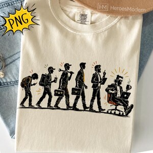 May include: A cream-colored t-shirt featuring a graphic illustration of the evolution of a person, starting as a student with a backpack and progressing through various professional stages, ending with a person sitting in an office chair with a laptop.