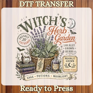 May include: A DTF transfer sheet featuring a graphic design titled Witch's Herb Garden. The illustration includes a wicker basket of lavender, a mortar and pestle, stacked books, a potion bottle, a crescent moon, and text labels like Freshly Gathered.