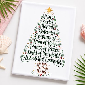 May include: A white rectangular canvas featuring a Christmas tree graphic formed by green text including Jesus, Savior, Messiah, Redeemer, Emmanuel, King of Kings, Prince of Peace, Light of the World, and Wonderful Counselor, topped with a gold star.