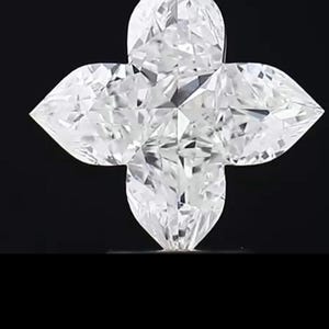 May include: A clear, multi-faceted diamond in a four-petal flower shape, set against a black background. The diamond's facets reflect light, creating a sparkling effect. The design is symmetrical and elegant.