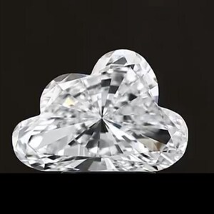 May include: A clear, cloud-shaped gemstone with a brilliant cut. The facets reflect light, creating a sparkling effect. The gemstone is set against a black background, highlighting its shape and clarity.
