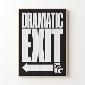 May include: A framed black and white print featuring the words "DRAMATIC EXIT" in bold white letters. Below the word "EXIT" is a white arrow pointing left, with a stick figure running towards the exit.