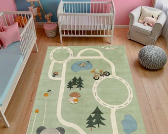 May include: A light green children's rug with a road design, featuring a panda, trees, mushrooms, and a pond. The rug has a playful design with a bicycle and car. The rug is placed in a nursery with two cribs and a chair.