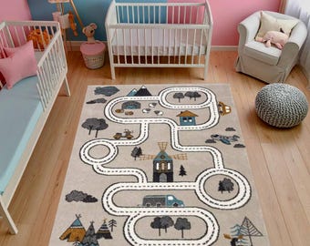 May include: A beige children's rug with a road map design featuring a windmill, houses, trees, and vehicles. The rug has a winding road pattern with white borders and is surrounded by a light brown border. The rug is placed on a wooden floor.